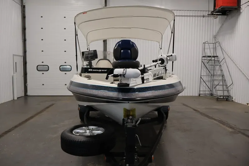 Slide: The Image of 2012 Ranger 1860 Angler boat in indoor storage, front view with canopy. - 2