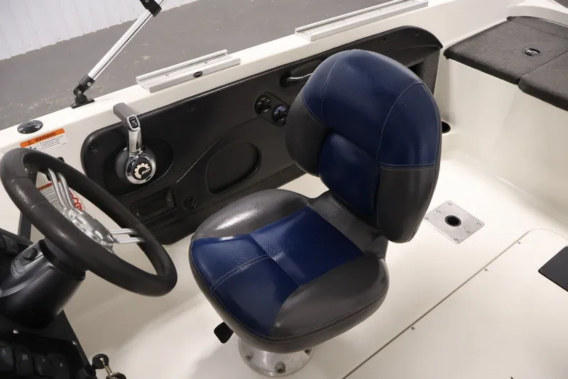 Slide: The Image of 2012 Ranger 1860 Angler boat interior with steering wheel and blue seat. - 31