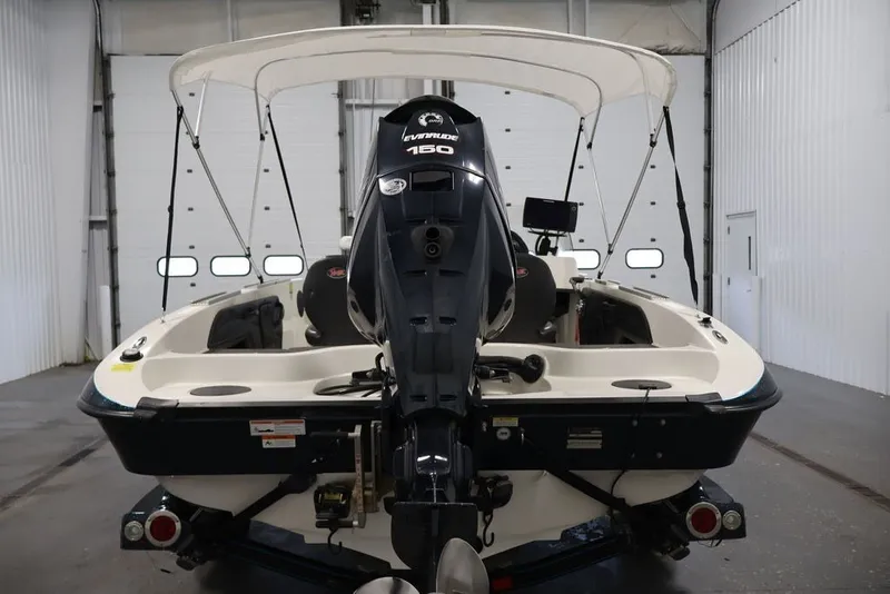 Slide: The Image of 2012 Ranger 1860 Angler boat with Evinrude 150 engine in a garage setting. - 7