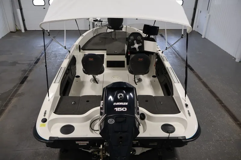 Slide: The Image of 2012 Ranger 1860 Angler boat with Evinrude 150 engine in a garage setting. - 11