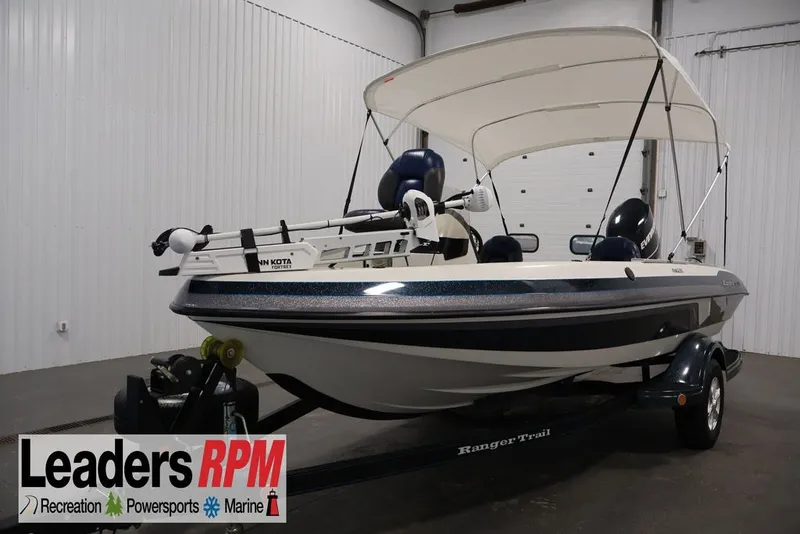 The Image of 2012 Ranger 1860 Angler boat with canopy on trailer in indoor showroom. - 1