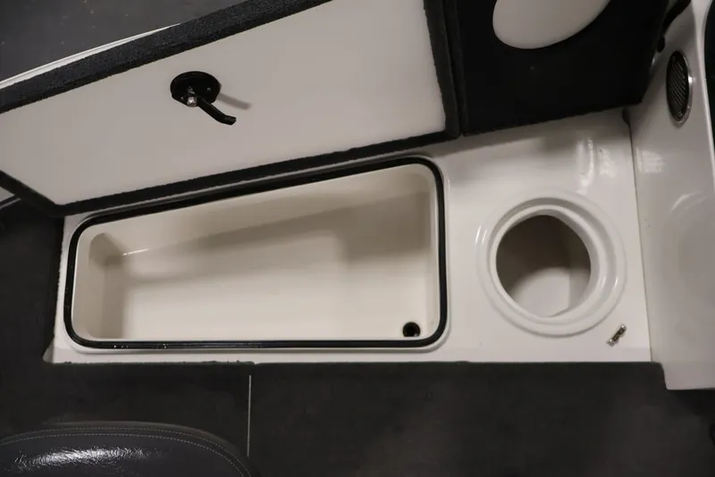 Slide: The Image of 2012 Ranger 1860 Angler boat storage compartment with open hatch and cup holder. - 33