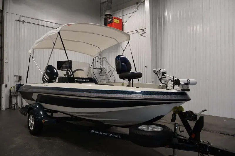Slide: The Image of 2012 Ranger 1860 Angler boat with canopy in a garage setting. - 4