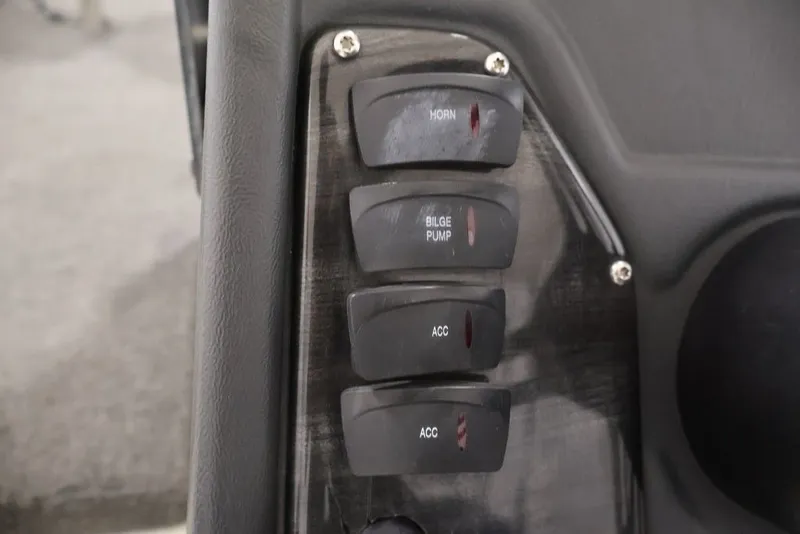Slide: The Image of Control panel of a 2012 Ranger 1860 Angler boat with labeled switches. - 17