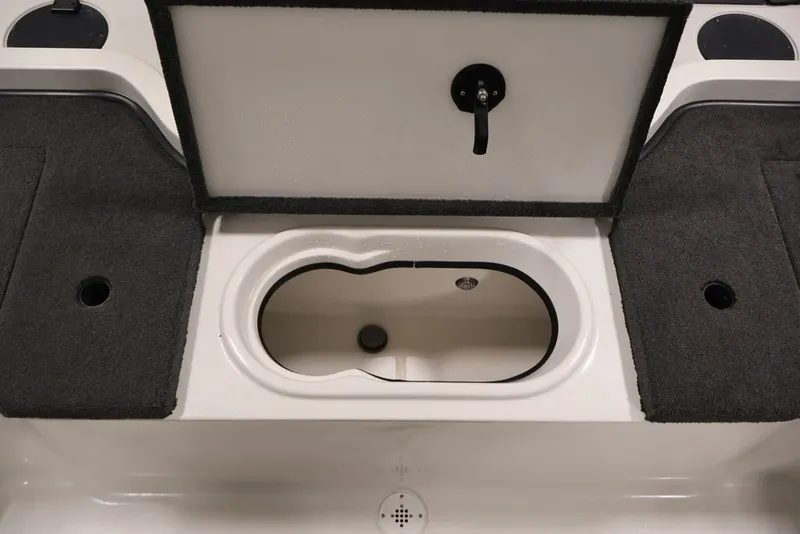 Slide: The Image of 2012 Ranger 1860 Angler boat storage compartment with open lid and carpeted surfaces. - 29