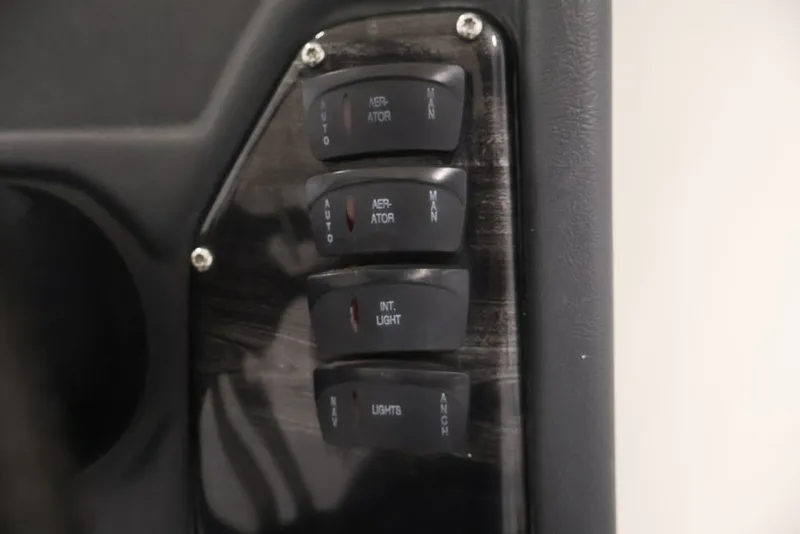 Slide: The Image of Control panel of a 2012 Ranger 1860 Angler boat with switches for aerator and lights. - 24