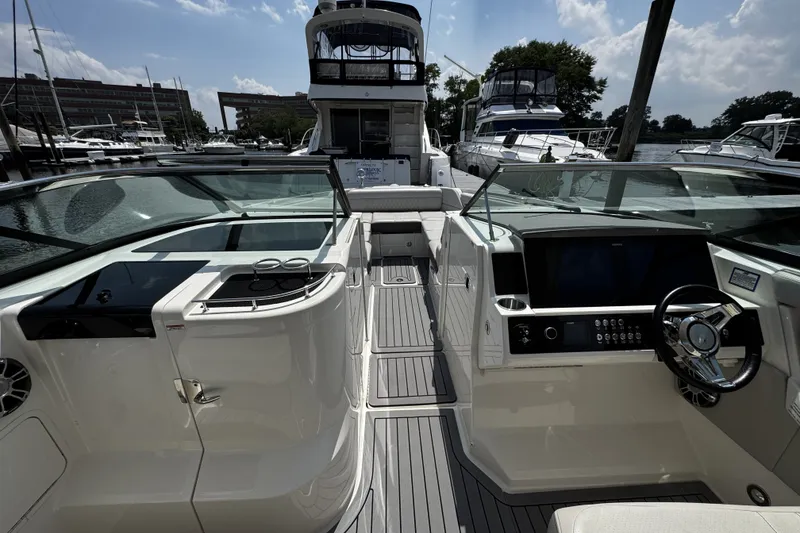 Slide: The Image of 2021 Sea Ray SLX 350 Outboard boat interior with sleek dashboard and seating. - 13