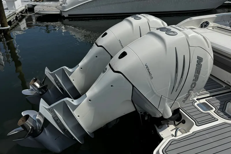Slide: The Image of Twin Mercury outboard engines on a 2021 Sea Ray SLX 350 boat at a marina. - 5