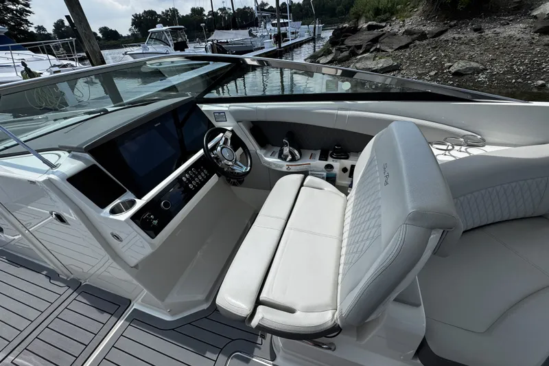 Slide: The Image of 2021 Sea Ray SLX 350 Outboard boat cockpit with modern controls and seating. - 14