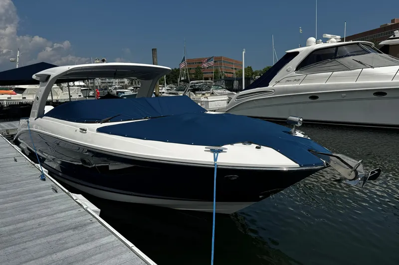 Slide: The Image of 2021 Sea Ray SLX 350 Outboard docked at marina under clear blue sky. - 3