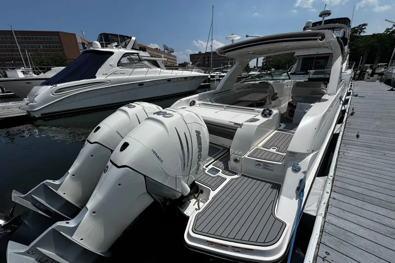 Slide: The Image of 2021 Sea Ray SLX 350 Outboard docked, showcasing dual engines and sleek design. - 6