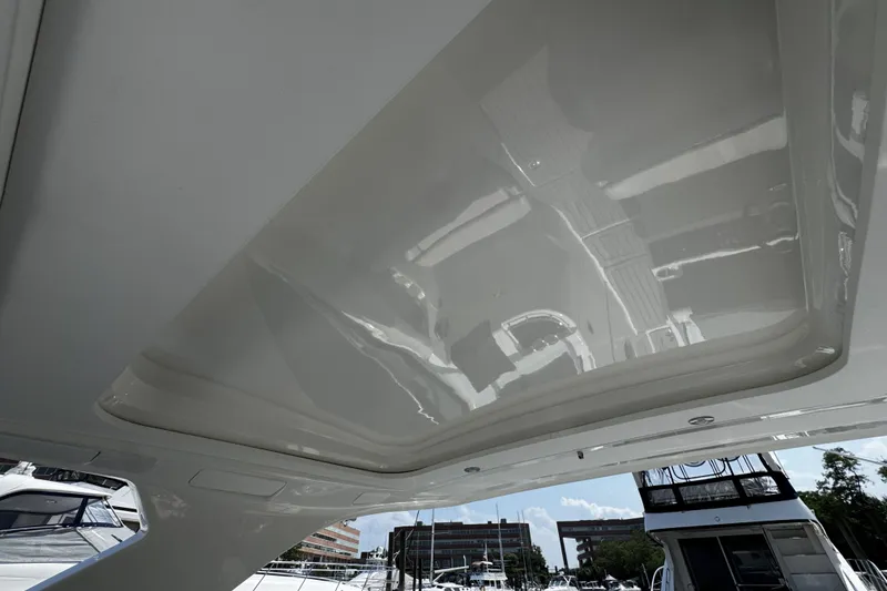 Slide: The Image of 2021 Sea Ray SLX 350 Outboard boat with sleek, reflective ceiling design. - 16