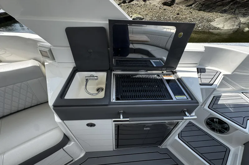 Slide: The Image of Luxury outdoor kitchen on 2021 Sea Ray SLX 350 Outboard boat, featuring grill and sink. - 10