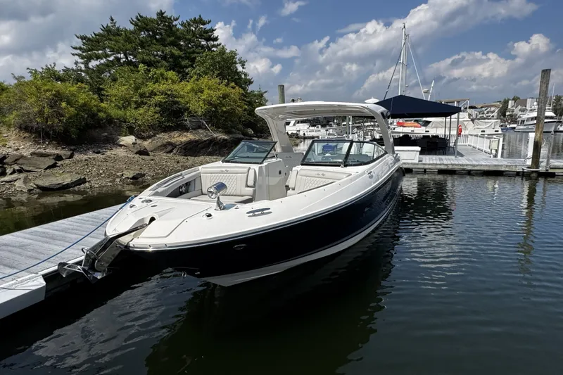 The Image of 2021 Sea Ray SLX 350 Outboard docked at marina under clear skies. - 0