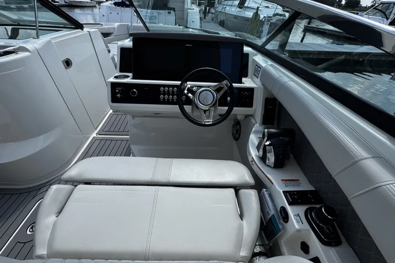 Slide: The Image of 2021 Sea Ray SLX 350 Outboard helm with modern controls and luxurious seating. - 15