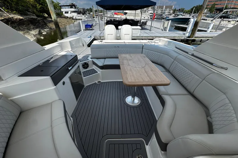 Slide: The Image of Luxurious 2021 Sea Ray SLX 350 Outboard boat interior with elegant seating and wooden table. - 11