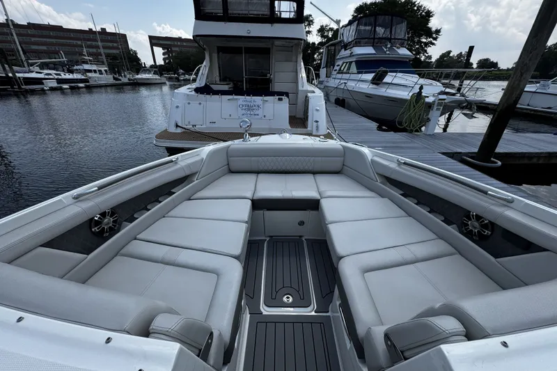 Slide: The Image of 2021 Sea Ray SLX 350 Outboard boat with spacious seating at a marina. - 17