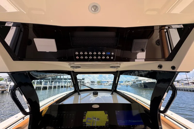Slide: The Image of 2021 Scout 425 LXF boat dashboard with advanced navigation controls and waterfront view. - 30