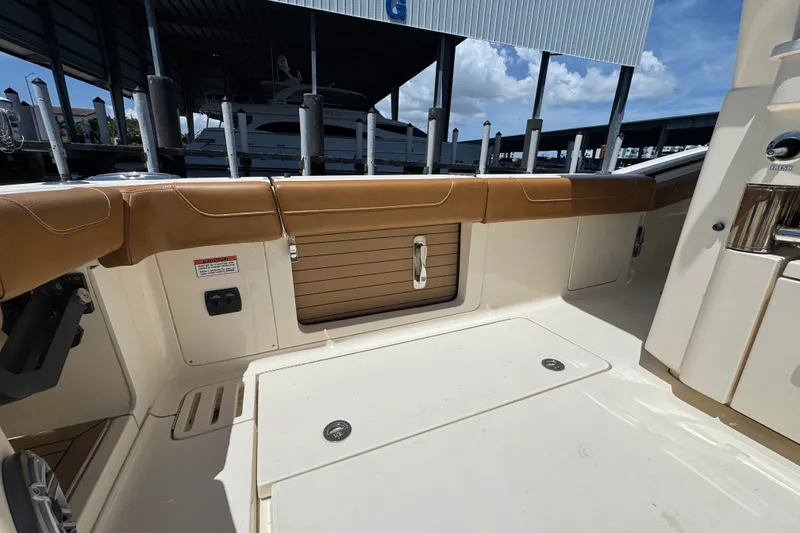 Slide: The Image of 2021 Scout 425 LXF boat interior with tan seating and storage compartments. - 38
