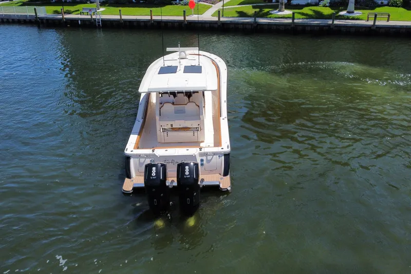 Slide: The Image of 2021 Scout 425 LXF boat with dual engines on calm water. - 17