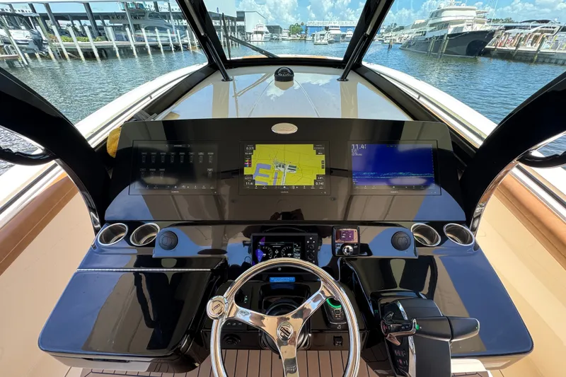Slide: The Image of Helm of 2021 Scout 425 LXF boat with advanced navigation displays and controls. - 29