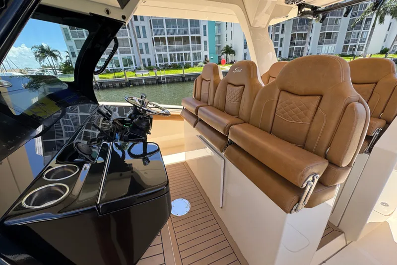 Slide: The Image of 2021 Scout 425 LXF boat interior with luxurious leather seating and modern helm controls. - 31