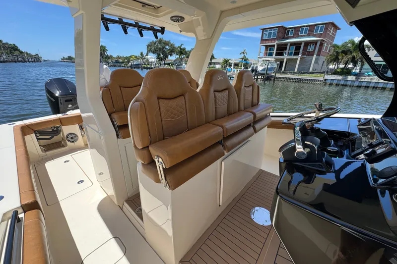 Slide: The Image of 2021 Scout 425 LXF boat interior with luxurious seating and modern helm. - 32