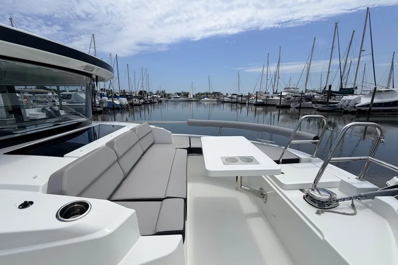 Slide: The Image of 2026 Jeanneau NC 895 Sport Series 2 boat with seating area in marina. - 19