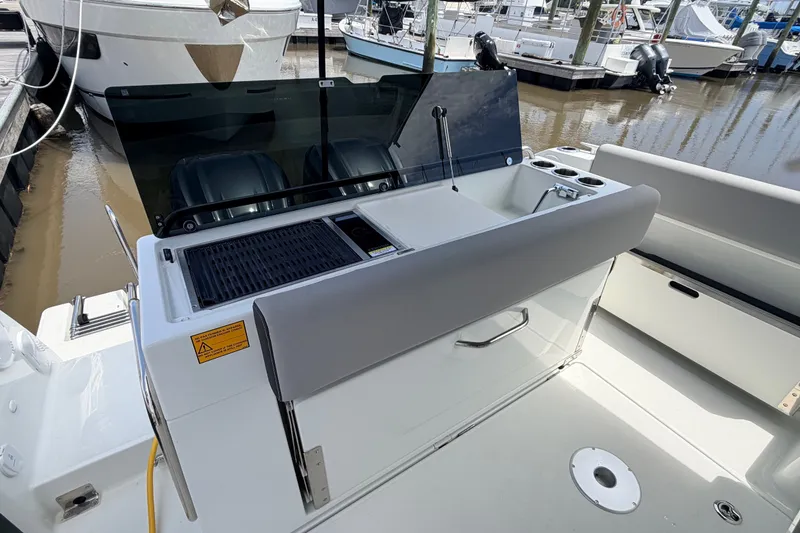 Slide: The Image of 2026 Jeanneau NC 895 Sport Series 2 boat deck with outdoor kitchen and seating area. - 12