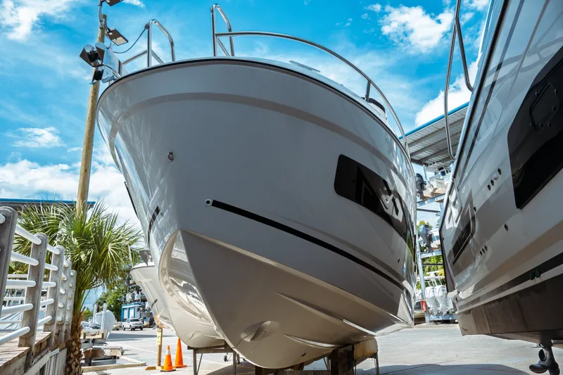Slide: The Image of 2025 Jeanneau NC 895 Sport Series 2 boat on display under a clear blue sky. - 2