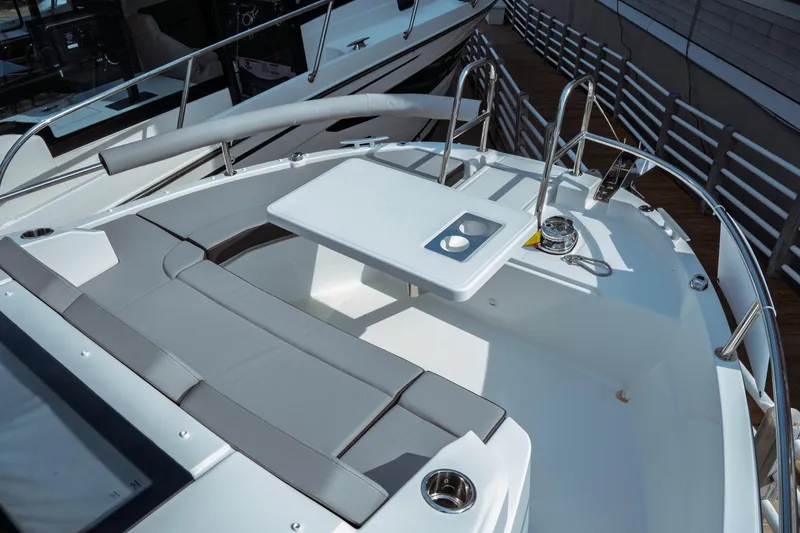 Slide: The Image of 2025 Jeanneau NC 895 Sport Series 2 boat deck with seating and table. - 16