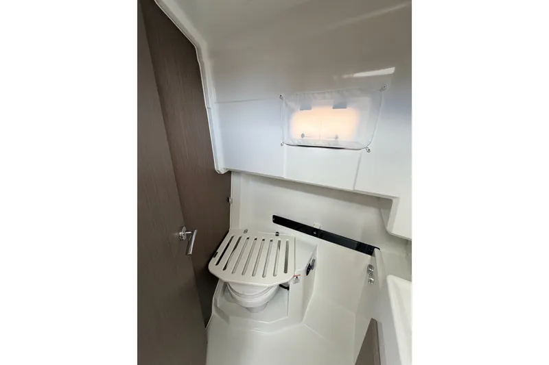 Slide: The Image of 2026 Jeanneau NC 895 Sport Series 2 boat interior bathroom with compact toilet and window. - 46