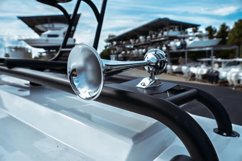 Slide: The Image of Close-up of Jeanneau NC 895 Sport Series 2 boat horn, 2025 model, with marina background. - 20
