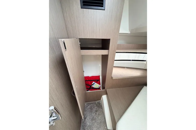 Slide: The Image of Interior storage of 2026 Jeanneau NC 895 Sport Series 2 boat, featuring open cabinet. - 43
