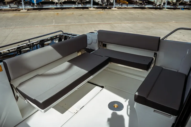 Slide: The Image of 2025 Jeanneau NC 895 Sport Series 2 boat seating area with cushioned benches. - 10
