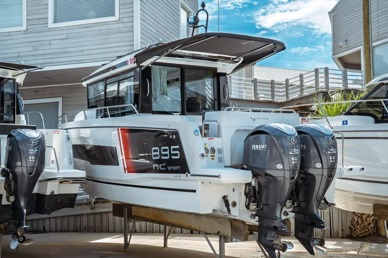 The Image of 2025 Jeanneau NC 895 Sport Series 2 boat with twin Yamaha engines, docked outdoors. - 0