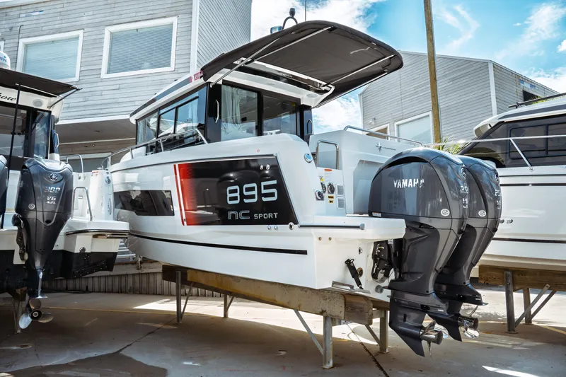 Slide: The Image of 2025 Jeanneau NC 895 Sport Series 2 boat with dual Yamaha engines on display. - 4