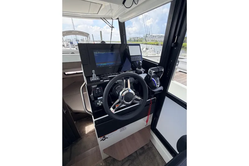 Slide: The Image of Helm of 2026 Jeanneau NC 895 Sport Series 2 with modern navigation controls. - 36