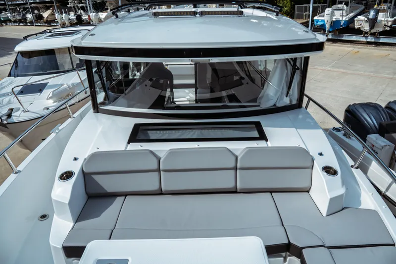 Slide: The Image of 2025 Jeanneau NC 895 Sport Series 2 boat with spacious seating and modern design. - 18
