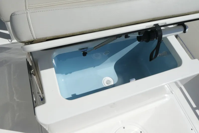 Slide: The Image of Livewell compartment in 2027 Boston Whaler 190 Montauk boat, featuring a cushioned seat. - 11