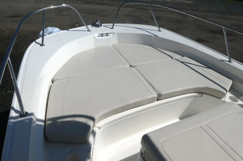 Slide: The Image of 2027 Boston Whaler 190 Montauk boat with cushioned seating in the bow area. - 8