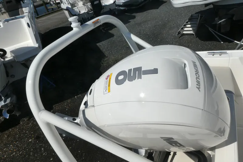 Slide: The Image of 2027 Boston Whaler 190 Montauk with Mercury outboard engine, showcased at a marina. - 4