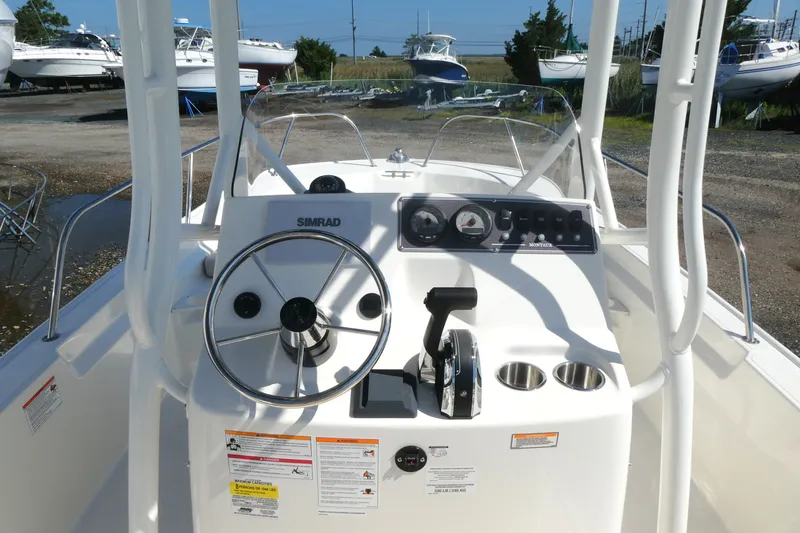Slide: The Image of 2027 Boston Whaler 190 Montauk boat dashboard with steering wheel and controls. - 7