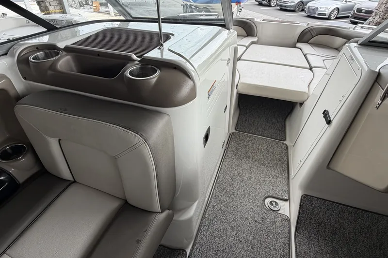 Slide: The Image of Interior of a 2012 Yamaha Boats 242 Limited S, featuring seating and cup holders. - 11