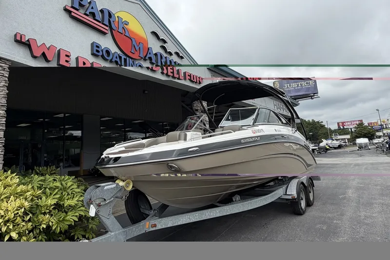Slide: The Image of 2012 Yamaha 242 Limited S boat on trailer outside dealership. - 2