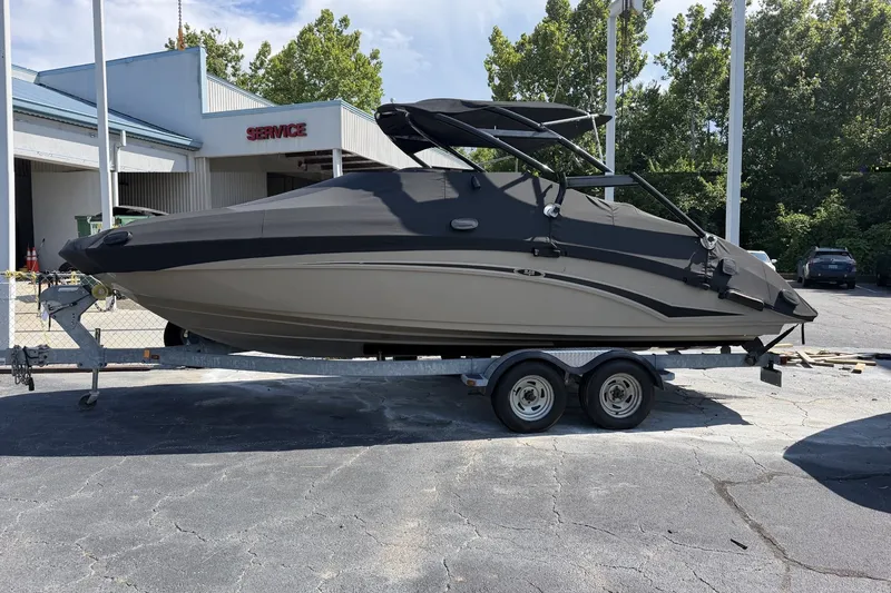 Slide: The Image of 2012 Yamaha Boats 242 Limited S on trailer, covered, parked outdoors. - 5