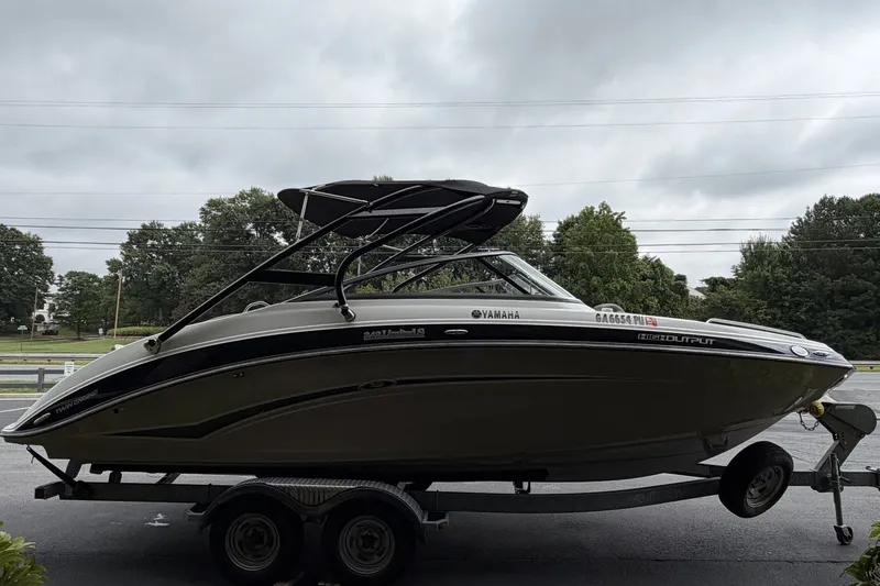 Slide: The Image of 2012 Yamaha 242 Limited S boat on trailer, parked outdoors. - 1