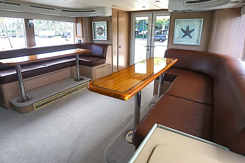 Slide: The Image of Luxurious 1996 Hatteras yacht interior with elegant seating and polished wood table. - 26