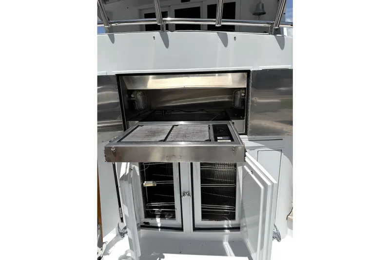 Slide: The Image of Outdoor grill and storage on a 1996 Hatteras yacht, featuring stainless steel design. - 35