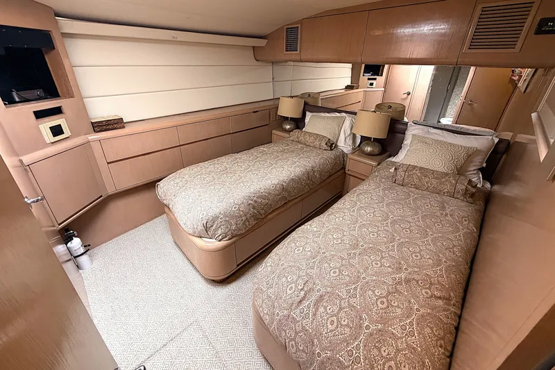 Slide: The Image of Luxurious 1996 Hatteras yacht cabin with twin beds, elegant decor, and ambient lighting. - 19